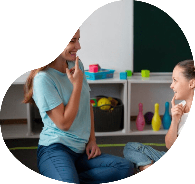 Behavior Support Psychologist helping a little girl in speech therapy